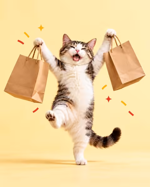 A joyful cat holding two shopping bags